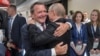 Former German Chancellor Gerhard Schroeder (left) hugs Russian President Vladimir Putin at the opening of the soccer World Cup in Moscow in 2018. 