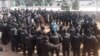 Участники протестной акции, окруженные сотрудниками спецподразделения полиции. Алматы, 28 февраля 2021 года