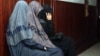 Жены подсудимых по делу "Терроризм" сидят в здании суда. Алматы, 10 сентября 2012 года. 