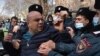 Armenian police detain an opposition protester at a rally to demand the resignation of prime minister in Yerevan on February 23.