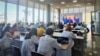 Kournalists watch a speech by Kazakh President Qasym-Zhomart Tokayev at the Kazmedia press center in Nur-Sultan in July 2022. 