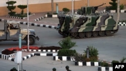 Yemeni armored personnel carriers are deployed outside the Central Bank in Sanaa on March 21.