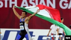 احسان حدادی در بازی آسیایی ۲۰۰۶ دوحه قطر با پرچم ایران دور افتخار می زند.