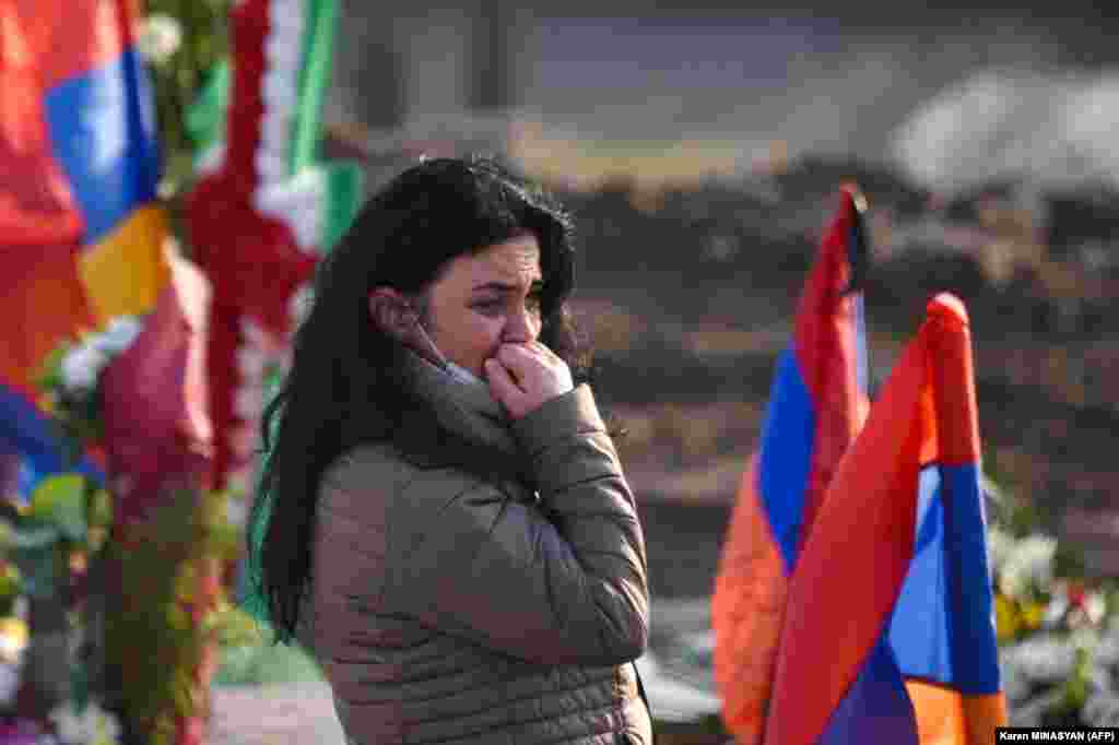 A woman cries at the Yerablur cemetery on December 19. 