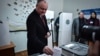 Moldovan President Igor Dodon casts his vote in parliamentary elections in a polling station in Chisinau on February 24. 