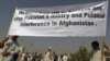 Men hold a banner aloft during a demonstration in Kabul against crossborder shelling attacks on August 30.