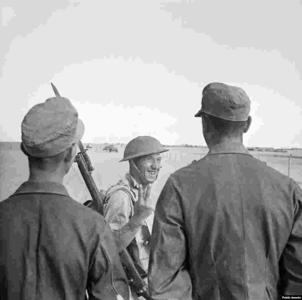 A British soldier gives a two-fingered salute to captured German soldiers. Winston Churchill celebrated the victory in parliament, declaring, “By a marvelous system of camouflage, complete tactical surprise was achieved in the desert.”