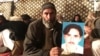 A member of Pakistan's Pashtun community holds a picture of Naqibullah Mehsud, whose extrajudicial killing by Karachi police sparked nationwide protests.