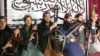 A photo taken at an undisclosed location, released by Tehrik-e-Taliban Pakistan (TTP) and received in December 2014, shows fighters who allegedly stormed an army-run school in Peshawar.