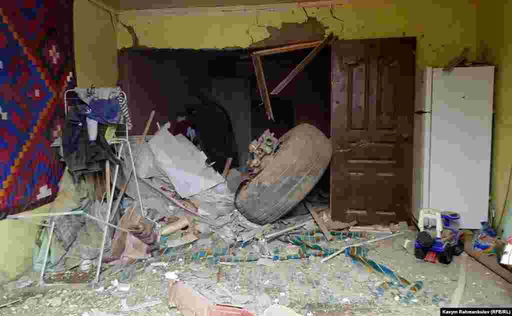 A section of the plane's landing gear inside a house. 
