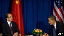U.S. President Barack Obama (right) speaks with Chinese Prime Minister Wen Jiabao during a bilateral meeting in Copenhagen earlier today.