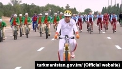 Gurbanguly Berdymukhammedov, Turkmenistan's president at the time, rides his bike in Ashgabat on June 2018 as part of a mass ride that set a Guinness World Record.