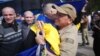 A Ukrainian POW is hugged after being released in a prisoner exchange with Russia, which took place at Ukraine's border with Belarus on May 23. 