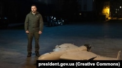 Ukrainian President Volodymyr Zelenskiy stands near a downed Iranian-made kamikaze drone in October.