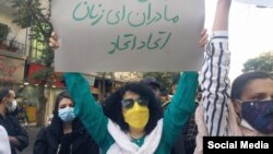 نرگس محمدی پلاکارد در دست در یکی از تجمع‌های اعتراضی