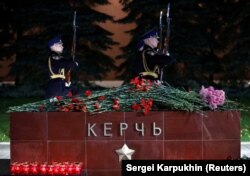 Flowers and candles at a memorial by the Kremlin walls in Moscow