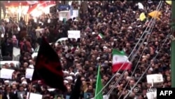 Islamic Republic of Iran Broadcasting shows Iranians chanting slogans as they march in support of the government in the northwestern city of Zanjan on January 1.