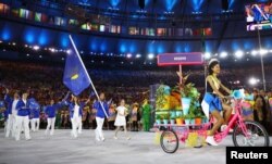 Majlinda Kelmendi of Kosovo carries the flag in the opening ceremony.