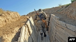 Nagorno-Karabakh -- An Armenian soldier of the self-proclaimed republic of Nagorno-Karabagh runs in trenches at the frontline on the border with Azerbaijan, 25Oct2012