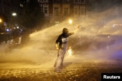 A police water cannon sprays a protester in Hamburg on July 6.
