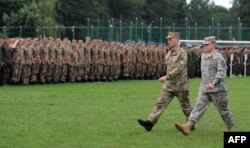Ukrainian and U.S. servicemen take part in an opening ceremony for joint military drills in Ukraine's Lviv region.