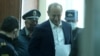 Ex-President Robert Kocharian is brought to a courtroom in Yerevan on May 8.