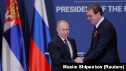 Russian President Vladimir Putin presents Serbian President Aleksandar Vucic with an Order of Alexander Nevsky after meeting in Belgrade in 2019.
