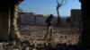 A police officer stands guard at a Hindu temple after a mob attack in a remote village in the Karak district in December 2020.