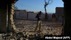 A police officer stands guard at a Hindu temple after a mob attack in a remote village in the Karak district in December 2020.