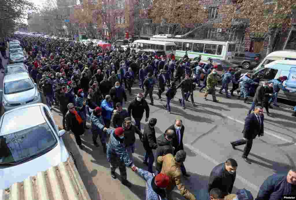 Pashinian (center left, holding a black loudspeaker) heads a protest march through Yerevan. He called on his supporters to meet in Yerevan's main Republic Square at 4 p.m. local time. 