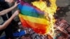 Anti-LGBT protesters burn an LGBT flag during the Kyiv Pride parade in June 2017.