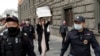 Russian police detain a protester holding a placard that says "Journalism is not a crime." (file photo)