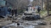 Dnipro residents inspect the aftermath of a Russian drone strike on the Ukrainian city late on March 28.