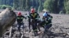 Rescue workers carry the body of a victim of a landslide, near Shovi, about 140 kilometers northwest of Georgia's capital, Tbilisi, on August 4.