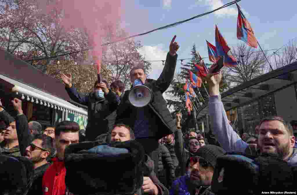 Protesters opposed to Pashinian shout slogans in central Yerevan. A February 25 letter signed by Armenian military leaders called for the prime minister's resignation. The letter came a day after Pashinian fired a top military official. 
