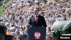 Polish President Karol Nawrocki speaks at a military parade in Warsaw on August 15.