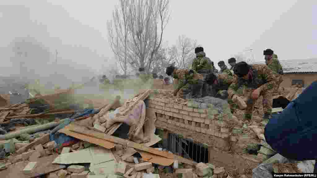 Damaged houses being searched. Around 20 homes are reported to have been destroyed in the crash. 