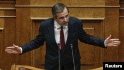 Prime Minister Antonis Samaras addresses parliamentarians before a voting for the 2013 budget in Athens on November 11.