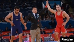 UK -- Armenia's Arsen Julfalakian (R) beats Azerbaijan's Emin Ahmadov on his way to a silver medal in the Men's 74Kg Greco-Roman wrestling during the London 2012 Olympic Games, 05Aug2012.