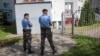 Belarusian police arrive at the office of the BelaPAN news agency in Minsk on August 7.