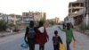 Displaced Palestinians, ordered by the Israeli army to leave the school in Beit Lahia where they were sheltered, arrive in Gaza City on October 19.