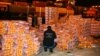 A customs agent checks boxes of oranges that included fake fruit filled with captagon after the shipment was intercepted at the Beirut port in December 2021.