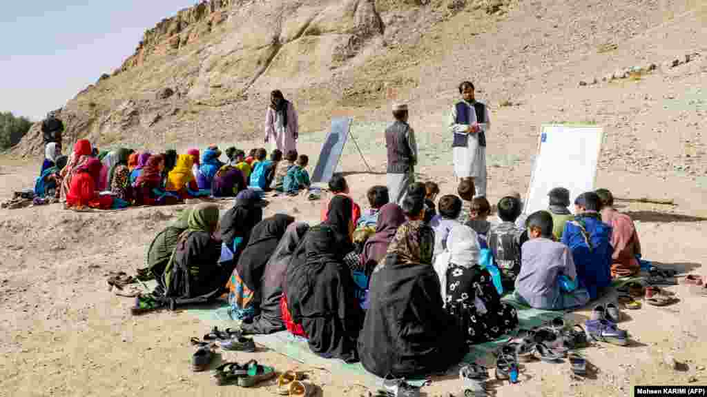 Despite the Taliban's nationwide ban on teenage girls attending school past the sixth grade, some are resorting to private education while others, such as these students, attend an open-air school in Firozkoh in Afghanistan's Ghor Province.