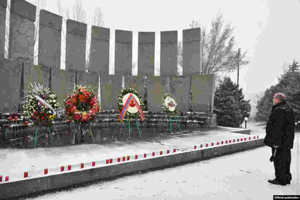 Armenian President Armen Sarkisian at Yerablur cemetery on December 20. Sarkisian has called for early parliamentary elections in response to widespread anger at the government's handling of the conflict and the resulting peace deal. 