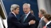 U.S. Secretary of State John Kerry (left) speaks with Swedish Foreign Minister Carl Bildt (center) as he arrives in Stockholm.