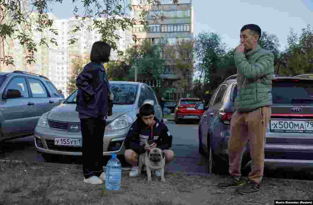 Residents await clearance to return to their homes following the drone attack. The conflict has seen Russia launch thousands of missiles and drone strikes on Ukraine, targeting civilian infrastructure and killing thousands. 