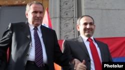 Former Armenian President Levon Ter-Petrosian (left) and Nikol Pashinian greet supporters in Yerevan in 2011.
