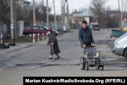 A small marketplace of grocery stores, pharmacies, COVID-testing sites, and taxi services has sprung up at the administrative border checkpoint at Stanytsya Luhanska.