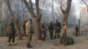 Afghan security forces inspect the site of a suicide attack in Kabul on January 5.