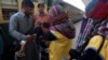 A health worker gives a polio vaccine to a child at a railway station, days after Pakistan launched an anti-polio campaign across the country, despite threats from the Taliban, in Karachi, Pakistan on Thursday, January 18.